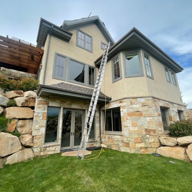 Residence in Midway, UT (December 2023): Post 4 - The third location where water was found to be entering inside the home was at the basement walkout. After removing some of the stone, we found that main source of water entry came from between the stone wall and the rock wall. We installed a seal that wrapped around the foundation wall to prevent future water entry. We also ran an underground drain line from the downspout to a drywell to bring water farther away from the wall.